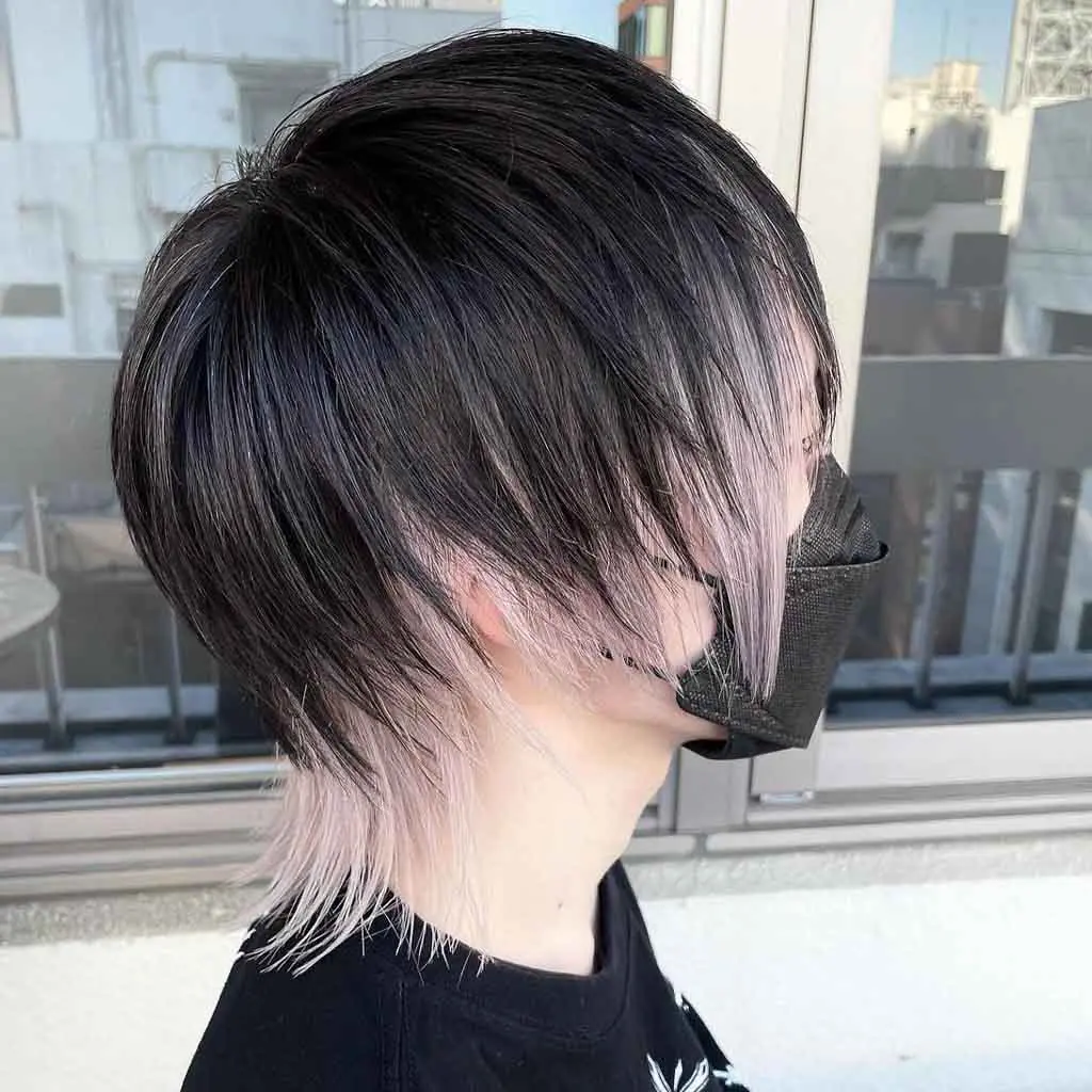 Woman rocking an anime-style choppy black and pearl blonde pixie wolf cut, featuring a playful and dynamic contrast