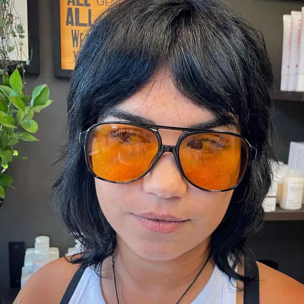 Woman with Short Wolf Cut With Short Curtain Bangs on Black Hair