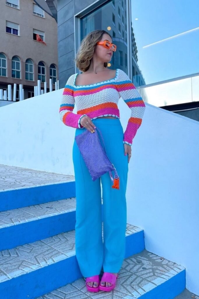 Bright blue pants with a colorful striped sweater