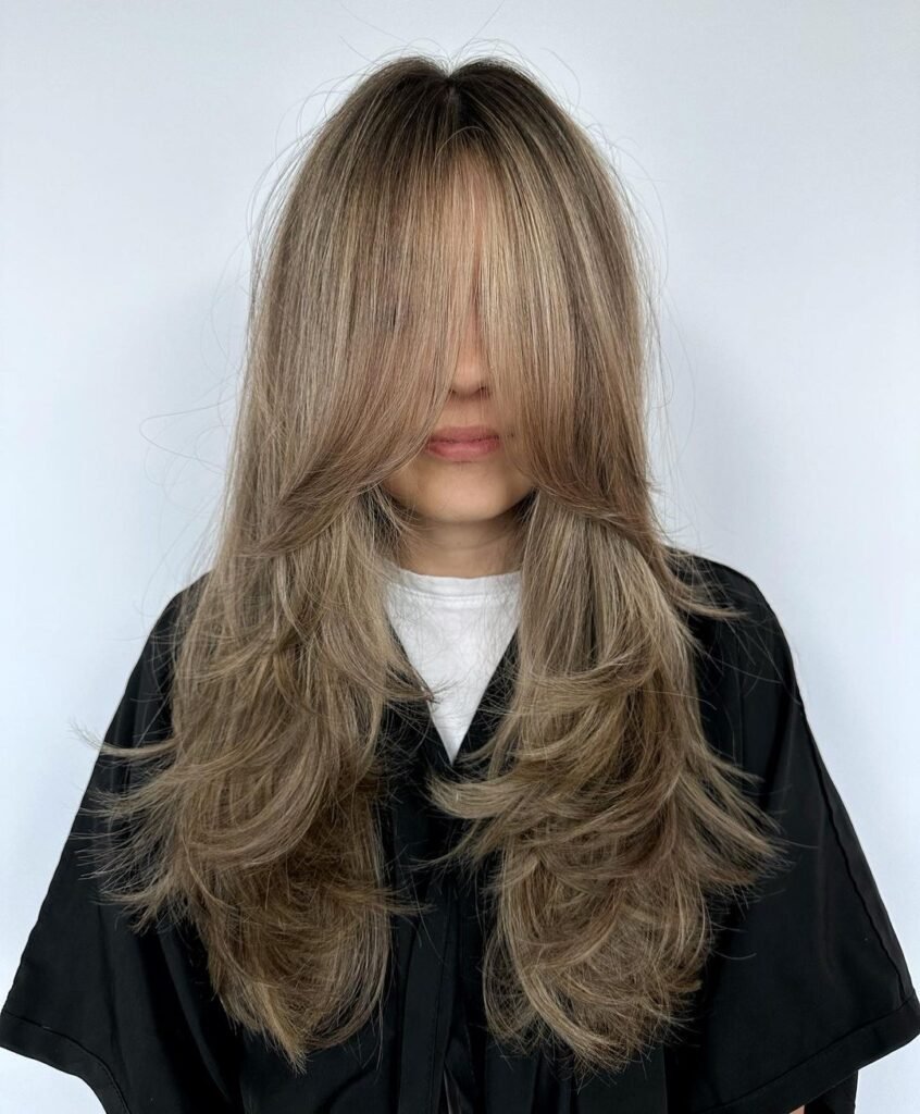 Butterfly Haircut With Curtain Bangs And Babylights