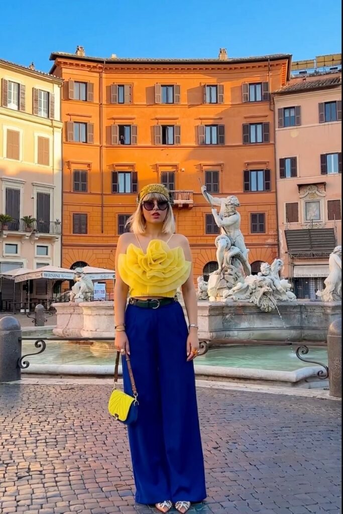 flowy yellow top with bold flower details paired with dark blue pants