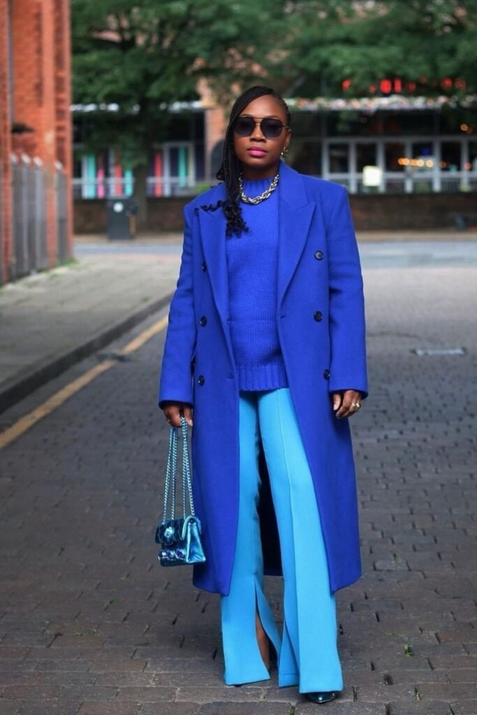 light blue pants with a deep blue sweater and a matching blue coat
