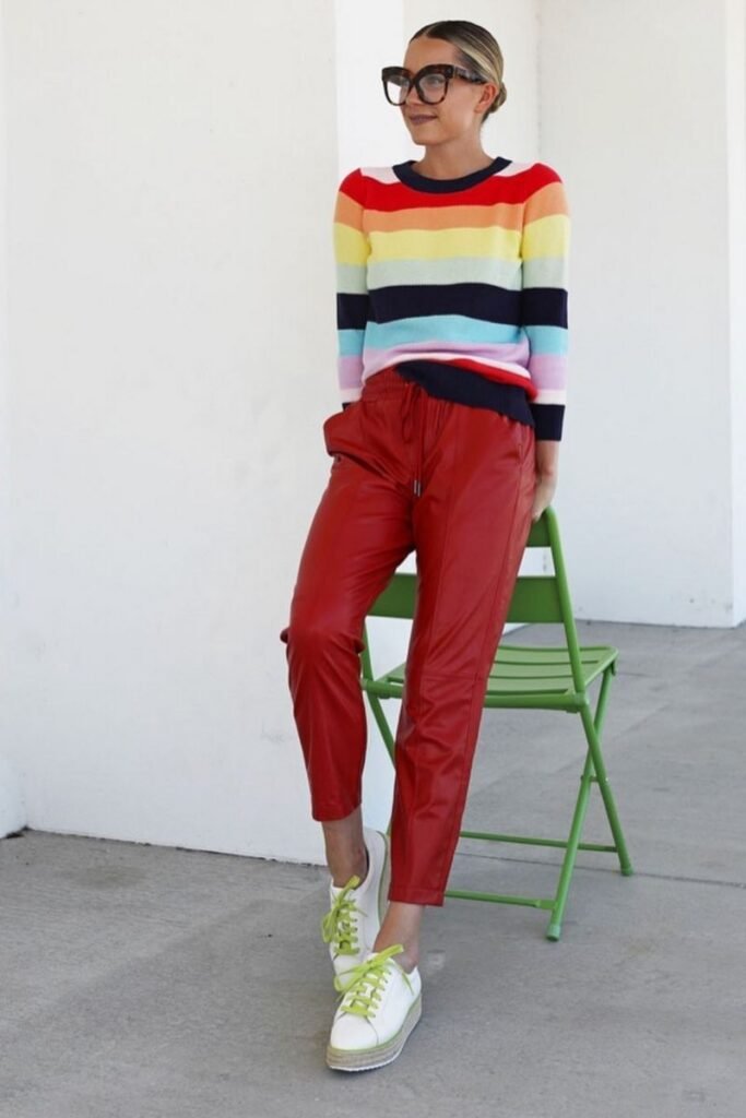 rainbow striped sweater with red leatherette pants