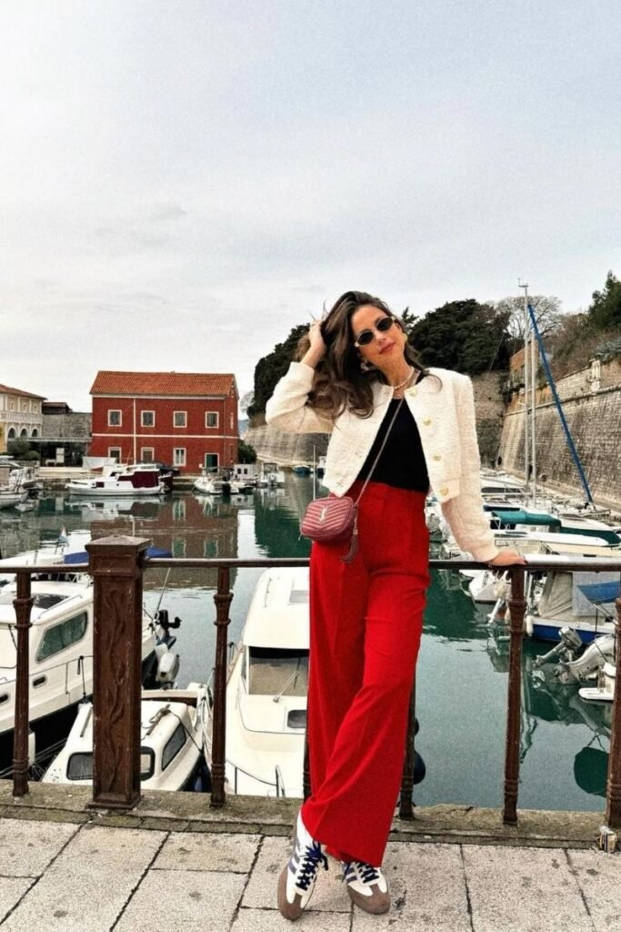 red pants with a black top and a white cropped jacket