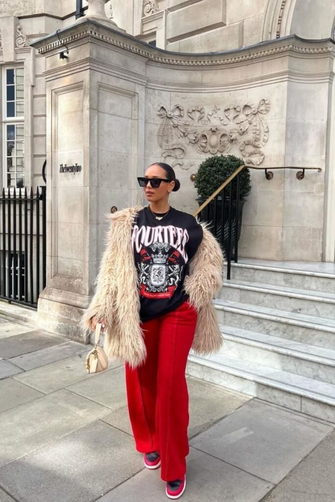 red pants with a graphic tee and a luxurious faux fur coat