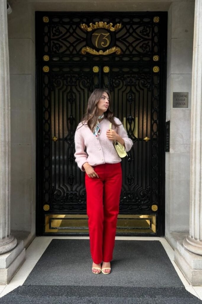 red pants with a soft pink cardigan
