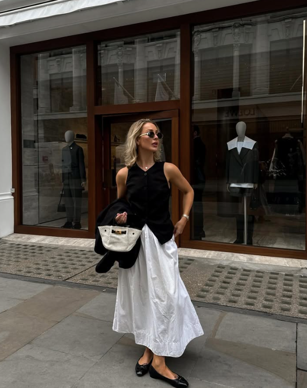 sleeveless jacket and white maxi skirt