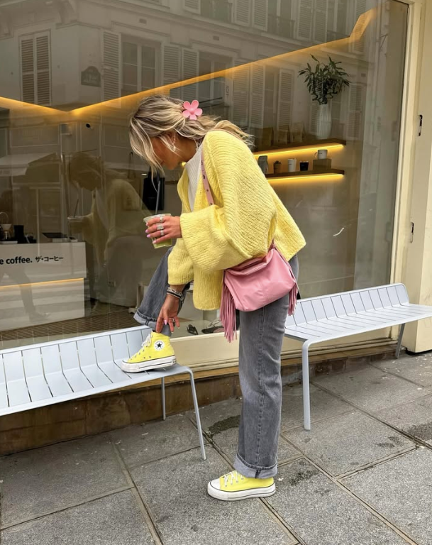 yellow sweater and grey jeans