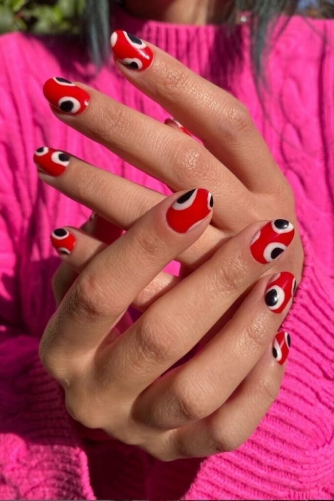 Graphic Red and Black Swirl Nails