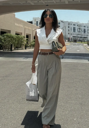Chic White Crop Top Tailored Grey Wide Leg Trousers Stylish Sunglasses Elegant Handbag