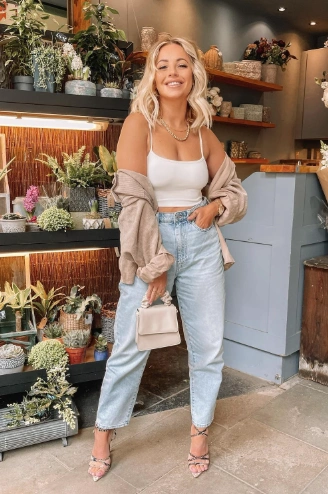 Chic White Crop Top Trendy Oversized Beige Shirt Light Wash Mom Jeans Strappy Heeled Sandals Elegant Mini Handbag