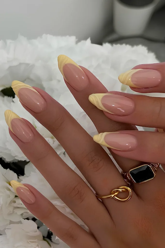 Yellow French mani with textured swirls.jpg