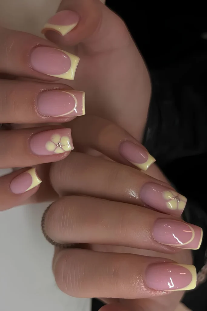Yellow French nails with blooming gel flowers.jpg
