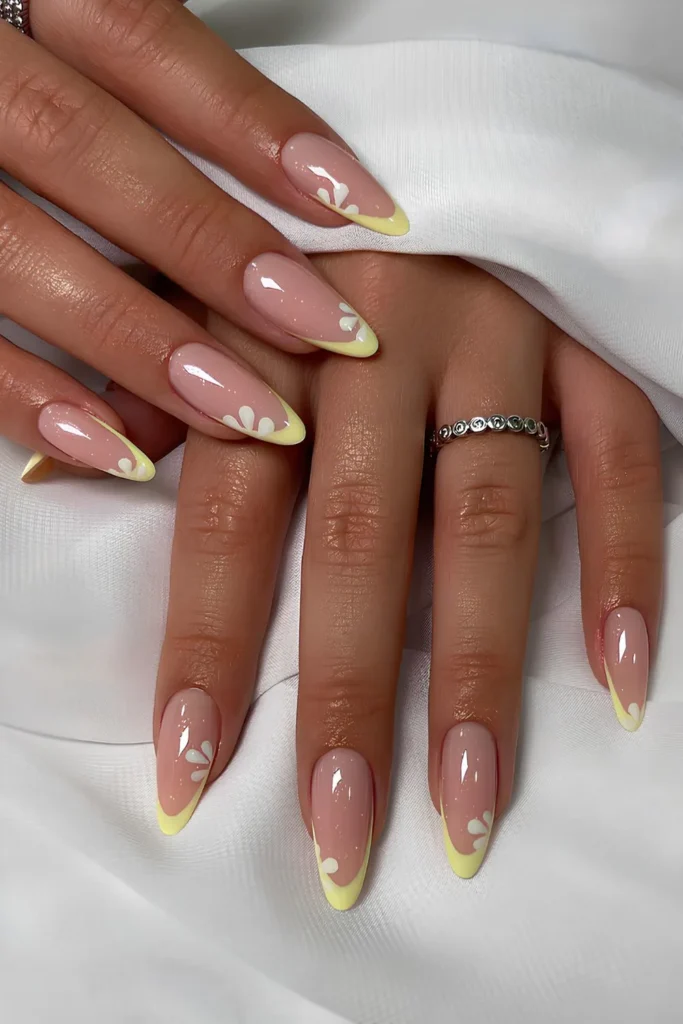 Yellow French tip nails with daisies.jpg