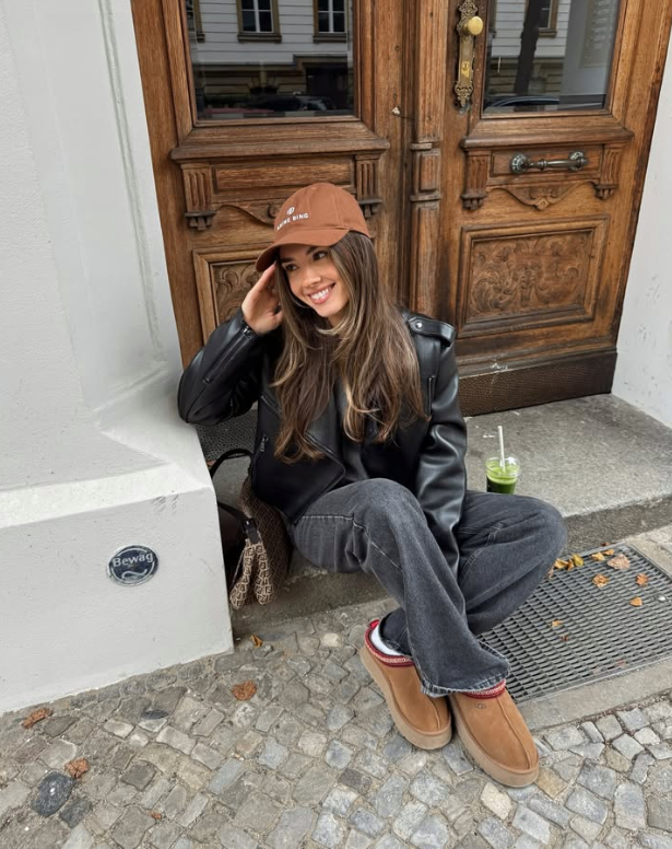black leather jacket dark jeans and tan slip on shoes