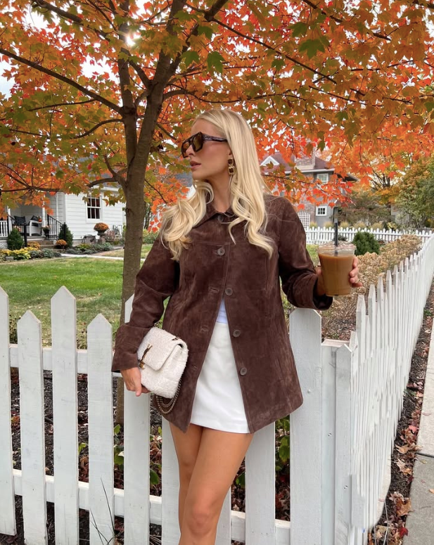 brown suede jacket and white skirt