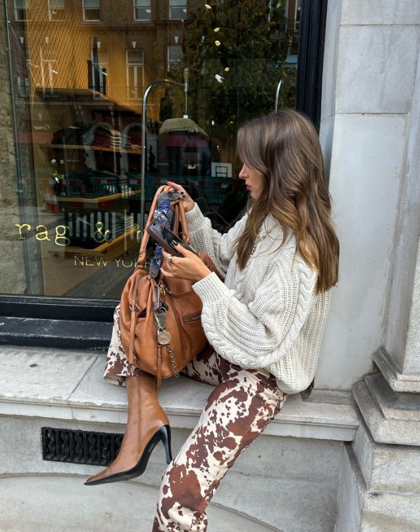 chunky white sweater and cow print pants