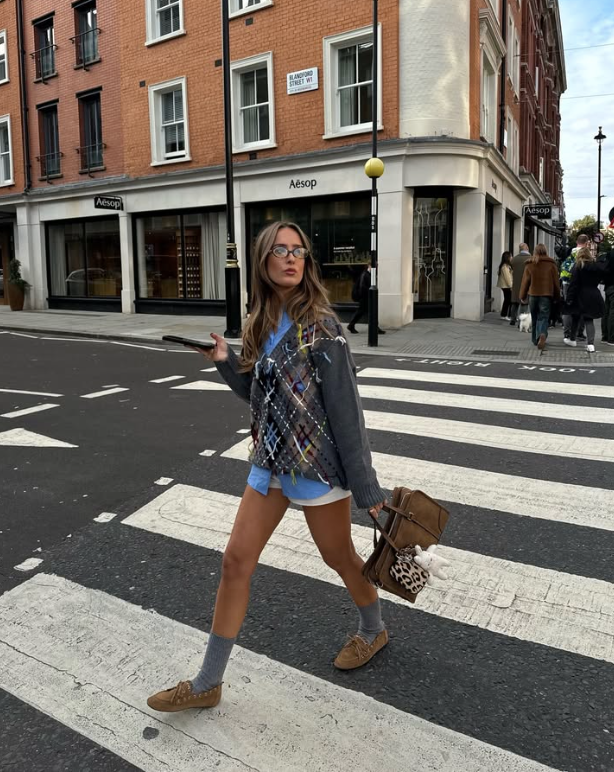 colorful patterned sweater blue shorts and brown shoes with gray socks