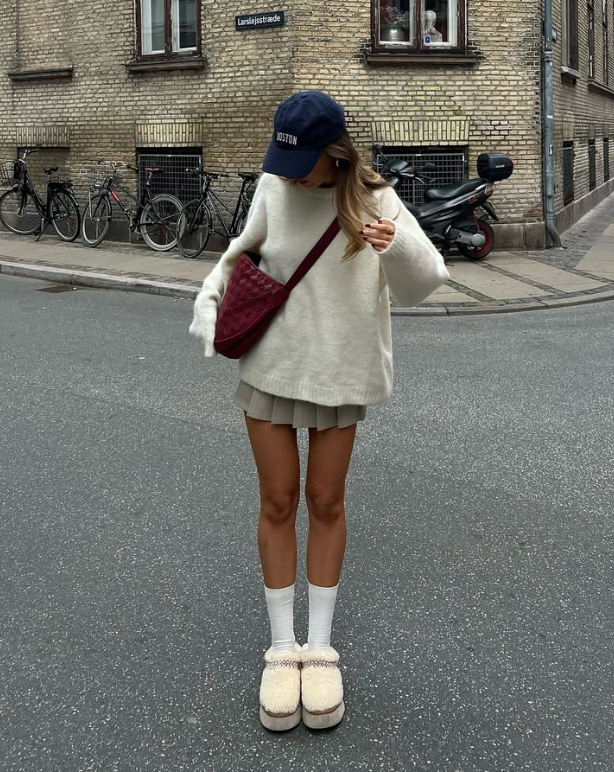 cream sweater pleated skirt and fluffy slippers paired with white socks