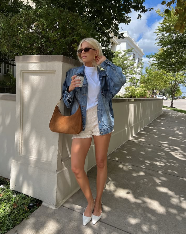 denim jacket over a white top and lace shorts