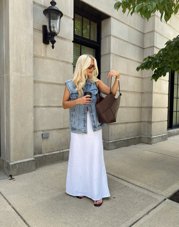 denim vest over a white maxi dress