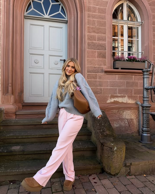 light blue sweater pink pants and brown shoes