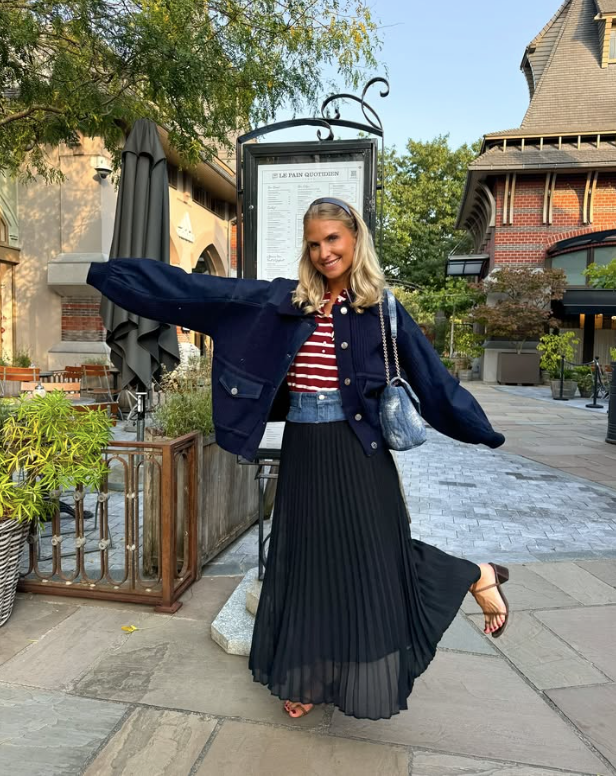 navy jacket a red and white striped top and a flowing black skirt