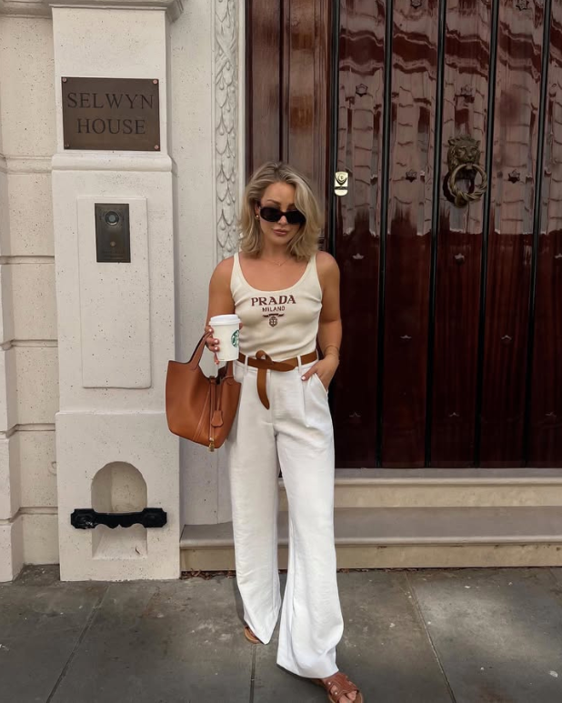 sleeveless Prada top and white wide leg pants with a brown belt