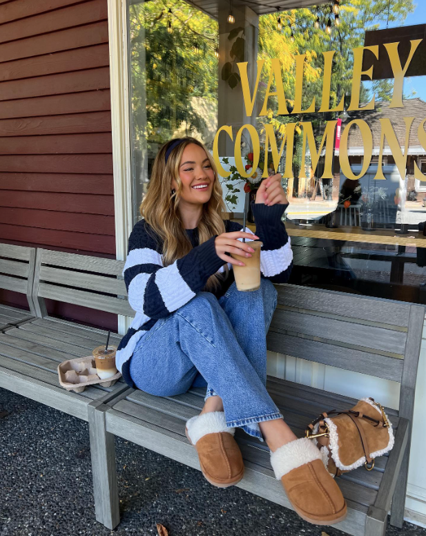 striped sweater blue jeans and cozy brown slippers