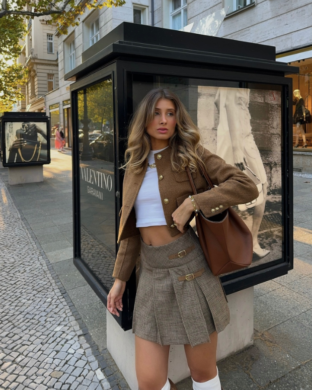 stylish brown jacket and plaid skirt paired with a white crop top