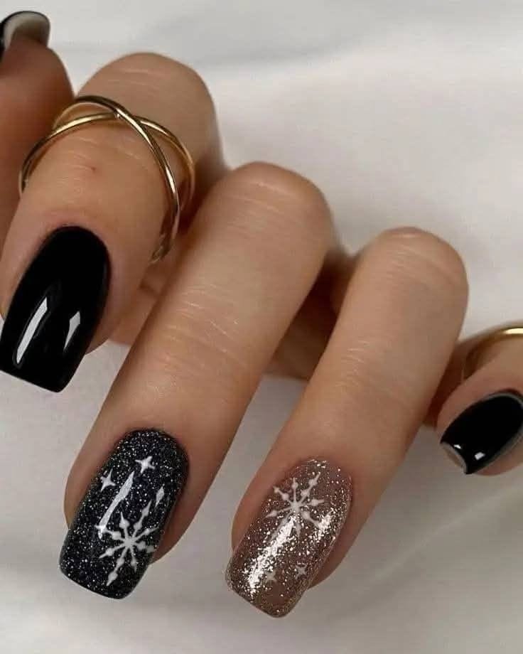Black Nails With Glitter Snowflakes and Gold Rings