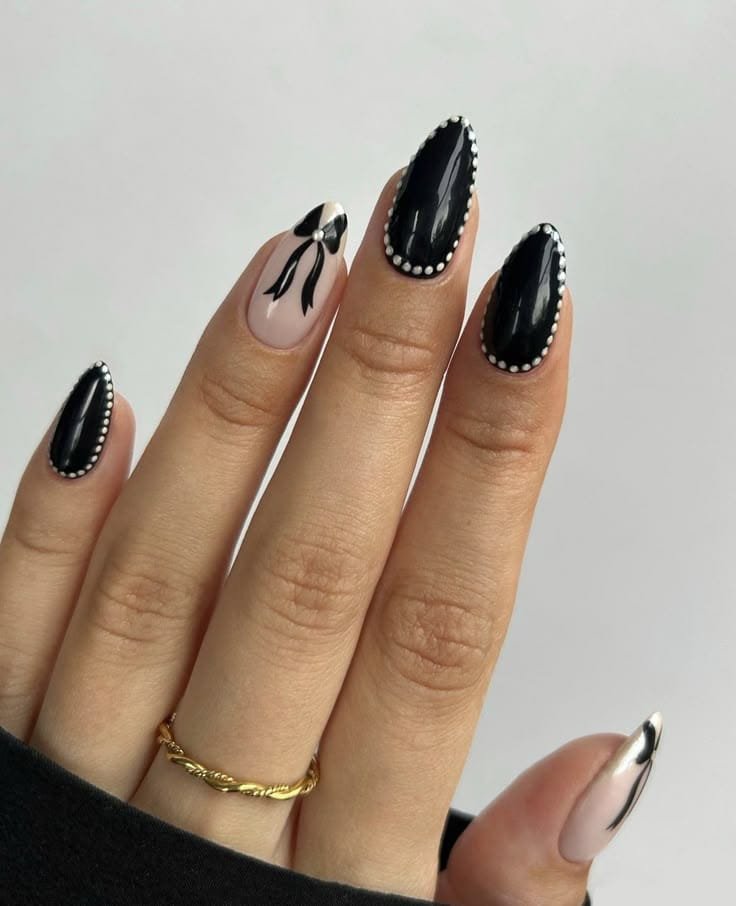 Black Nails With White Dots and a Cute Bow Accent