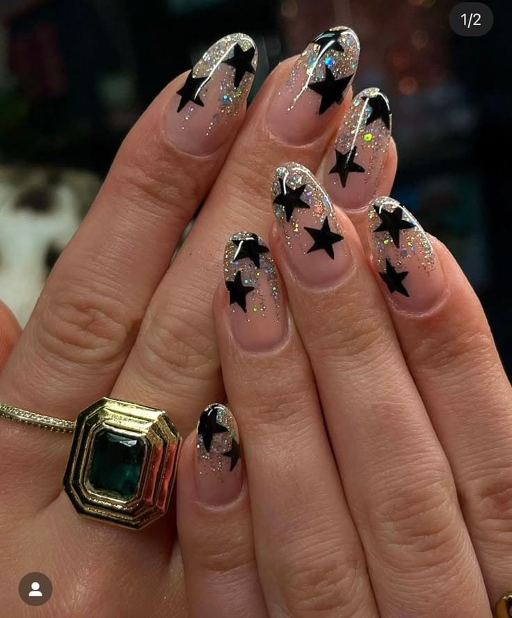 Black Star Nails With a Green Gem Ring