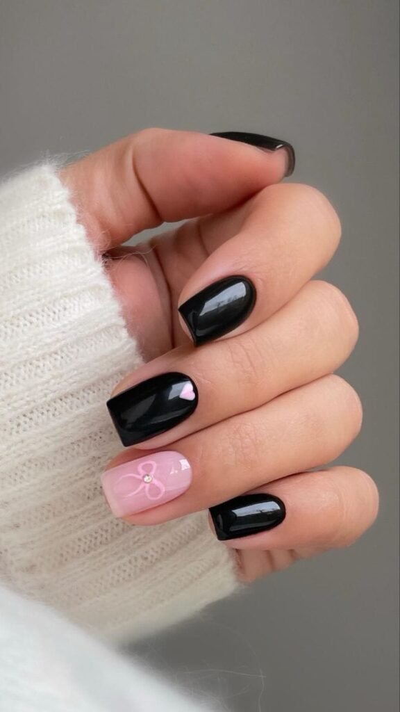 Glossy Black Nails with Pink Accent Bow Detail