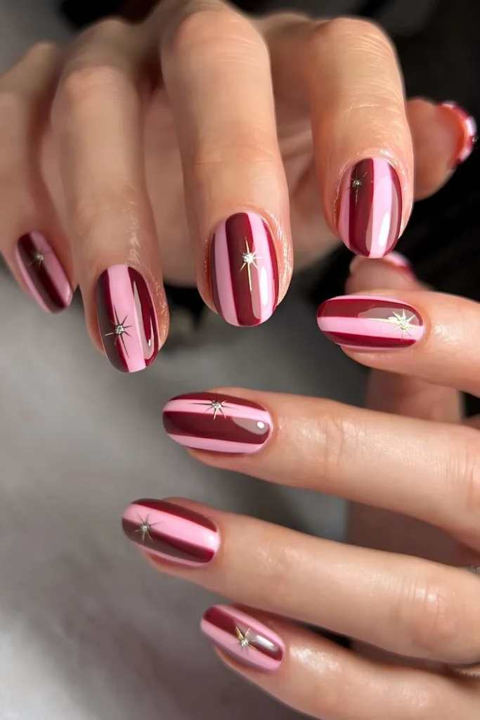 Burgundy and pink striped Christmas nails.jpg