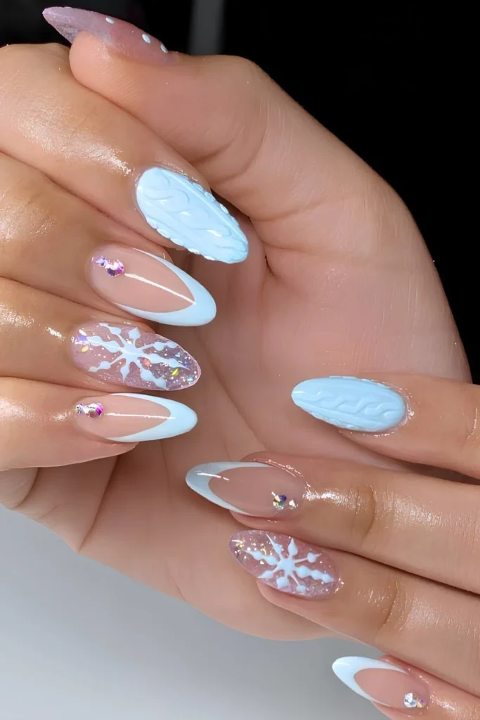Light blue nails with snowflakes and gems.jpg